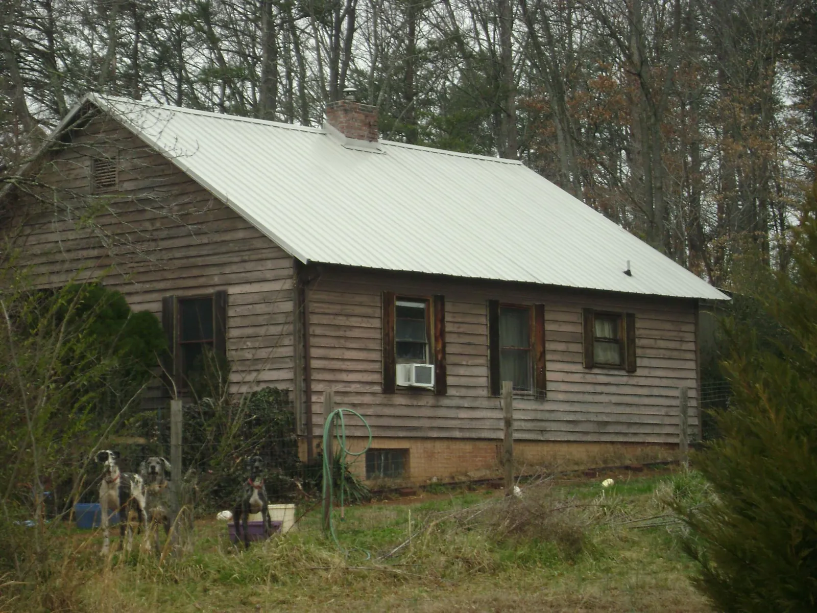 White metal roof on an old wood sided farmhouse, from a Metal Roof Installation job in Pembroke